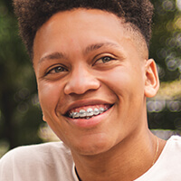 ortho-metal-braces smiling boy wearing braces